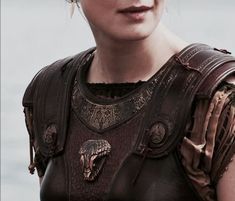 a close up of a person wearing a leather outfit with an animal head on it