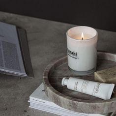 a candle and some soap on a tray