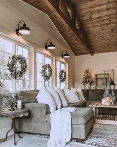 a living room filled with furniture and wreaths