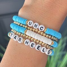 University of North Carolina Tar Heels bracelet  This listing is for ONE handmade heishi bracelet. Or you can the 3 bracelet stack! Coordinating earrings also available. Great birthday gift or graduation gift for a UNC student, fan, grad, alumni, mom, the list is endless! 14k Gold stacking bracelet can be found here: https://braceletisland.etsy.com/listing/1416856385 Burlap Gift Bag w/Tag can be found here... https://braceletisland.etsy.com/listing/1587395371  SIZE  * Stretch Bracelet, size is approximately 6 3/4"-7" (fits small to medium wrists). If you need a different size please let us know in notes at checkout!  PACKAGING  * Each bracelet order will be presented with a Bracelet Island presentation card and wrapped in brown paper dotted w/gold specs and tied with a burlap string. Ready Blue Stacked Bracelets With Round Beads, Blue Stacked Beaded Bracelets, Blue Stacked Bracelets For Gift, Blue Stacked Bracelets Gift, Adjustable Stacked Blue Bracelets, Blue Stacked Bracelets As Gift, Blue And White Jewelry, Unc College, College Jewelry