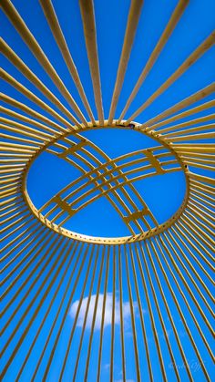 the inside of a large metal structure with blue sky in the backgroung