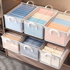 the drawers are organized with folded towels and other items in clear plastic bins for storage