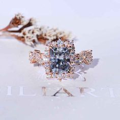 an engagement ring with a blue diamond surrounded by white flowers