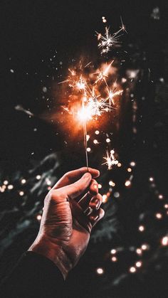 a person holding a sparkler in their hand