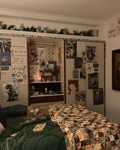 a bed room with a neatly made bed and lots of pictures on the wall