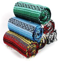 four different colored rugs stacked on top of each other