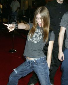 a young woman is dancing on the red carpet