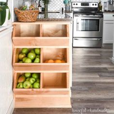 an open kitchen cabinet filled with apples and oranges