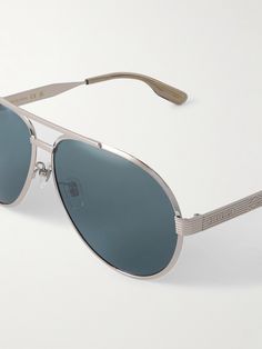 Aviator-style sunglasses have been worn by some of history's most stylish men, from Paul Newman to Brad Pitt. Gucci Eyewear's version has been made in Japan from silver-tone metal and detailed with wide, logo-engraved arms and a classic double bridge. Most Stylish Men, Gucci Eyewear, Paul Newman, Style Sunglasses, Summer Sunglasses, Aviator Style, Stylish Watches, Sunglasses For Men, Sports Accessories