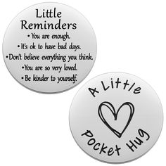 two badges with the words little reminders and a heart on them, both written in black ink