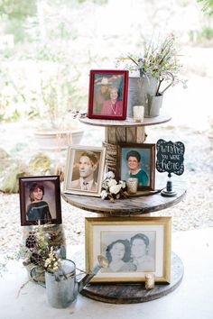 three tiered display with pictures and family photos on the top, surrounded by flowers