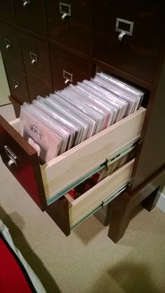 a drawer with many files in it on the floor