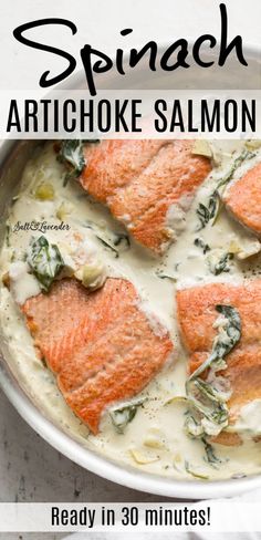 salmon with spinach artichoke sauce in a pan