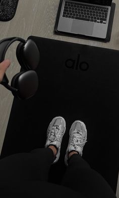 a person sitting at a desk with their feet up on a laptop and headphones