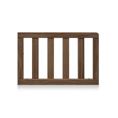 a wooden baby crib with bars on the top and bottom rail, against a white background