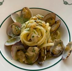 pasta with clams and sauce in a white bowl