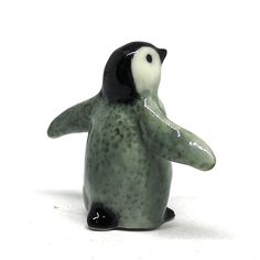 a ceramic figurine of a black and white penguin