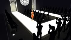 a woman in an orange dress walking down a runway