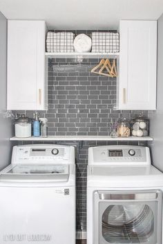 a white washer and dryer sitting next to each other in a laundry room