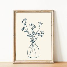 a drawing of flowers in a vase on a shelf next to a wall mounted art print