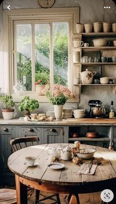 an old fashioned kitchen with pots and pans on the table