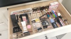 an organized drawer with makeup and eyeliners