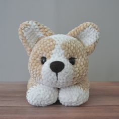 a small stuffed animal sitting on top of a wooden table