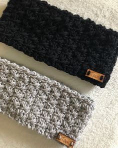 two crocheted headbands laying next to each other