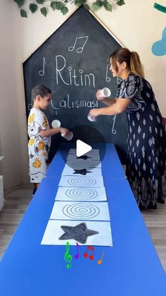 two children are playing with an interactive blackboard on the table in front of them