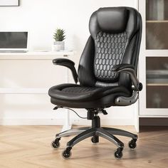 a black office chair sitting on top of a hard wood floor