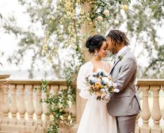 a bride and groom pose for a photo on their wedding day