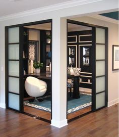 an open door leading into a living room with wood floors and white furniture in it