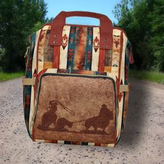 "This Western Themed Backpack features a vibrant saddle blanket & Team Roper leather detailed design which is digitally printed directly to the item. This bag can be PERSONALIZED with your name, initials, monogram, Business Logo or Your Ranch Brand - You can also order it without the personalization option if your prefer. STYLISH while still offering STRONG, STURDY construction this multipurpose backpack can be used in MANY WAYS - use it as a daily use backpack, stow-away travel carry-on bag, diaper bag and more! DEEP pockets, wide carry HANDLES - rather than a \"loop\" at the top as is common with most backpacks - These same handles also Slide Right Over the Telescoping Pull Handle of the Suitcases, Plus an insulated front pocket that will hold a freezer pack and 3 cans, or bottles. The s Brown Standard Backpack For Overnight Trips, Brown Backpack For Overnight Trips, Multicolor Rectangular Backpack For Outdoor Activities, Rectangular Multicolor Backpack For Outdoor Activities, Brown Tote Backpack For Outdoor, Multicolor Standard Backpack For Adventure, Western Style Travel Bag With Leather Backing, Multicolor Adventure Backpack, Western Hand Tooled Travel Bag