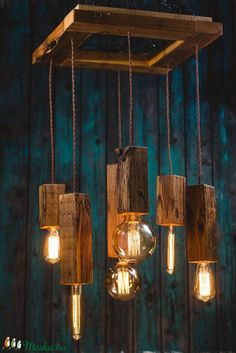 some light bulbs hanging from a wooden beam