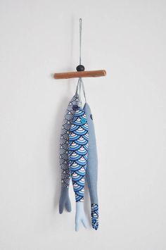 a fish hanging from a hook on a wall