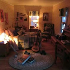 a bedroom with a guitar on the floor next to a bed and a table in front of it