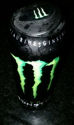 a black and green monster energy drink with the word's logo painted on it