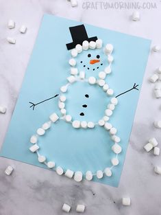 a snowman made out of marshmallows on a sheet of paper