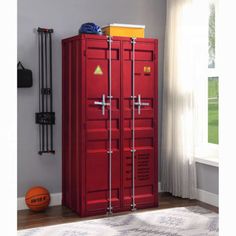 a room with a red locker next to a basketball ball on the floor and a white rug