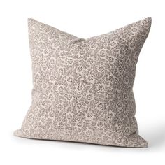 a pillow with a floral pattern on the front and back, sitting on a white background