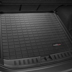 the trunk area of a car with its cargo compartment open and floor mats folded down