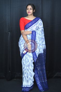 Weaver communities of Maniabandha and Nuapatana of Odisha traditionally weave this kind of saree. Common motifs are star, temple, conch, rudraksh, fish, chakra, lotus etc. The inspiration of all its designs comes from nature. It is the best of single ikat; one of warp and weft is tied and dyed prior to weaving. The borders and the pallas have tremendous variety and each one of them is attractive and praiseworthy. Specification:  Occasion: Festive Wear Fabric: Khandua Cotton Primary Color: White Blue Ikat Print Saree For Diwali, Festive White Ikat Print Saree, White Ikat Print Dupatta, Fitted Ikat Print Saree, Traditional Ikat Print Pre-draped Saree For Festivals, Chakra Lotus, Festive Wear, Les Chakras, Handloom Saree