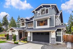 a two story house with gray siding and white trim