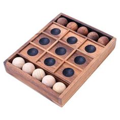 a wooden box filled with black and white balls