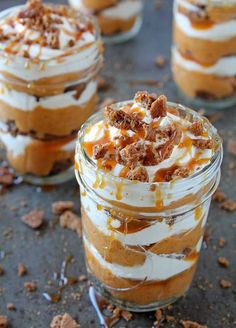 three desserts in small glass jars with toppings on the top one is topped with whipped cream and caramel