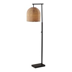 a floor lamp with a brown shade on it's side and a black base