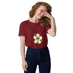 The smiley daisy face t-shirt is a vibrant and cheerful garment that features a unique design of a smiling face with daisy flowers as eyes. This t-shirt is crafted with high-quality materials to ensure comfort and durability. The bright colors and playful design make it a perfect choice for those who want to add a touch of positivity and happiness to their wardrobe. Whether you're looking to spread joy or simply express your love for nature, the smiley daisy face t-shirt is a delightful addition to any casual outfit. Made from 100% organic ring-spun cotton, this unisex t-shirt is a total must-have. It's high-quality, super comfy, and best of all--eco-friendly. * 100% organic ring-spun cotton * Fabric weight: 5.3 oz./yd.² (180 g/m²) * Single jersey * Medium fit * Set-in sleeves * 1 × 1 rib Cute Cotton Tops With Smiley Face, Summer Cotton Tops With Smiley Face, Cotton Smiley Face Top For Summer, Spring Smiley Face Short Sleeve T-shirt, Cotton Daisy Print T-shirt With Relaxed Fit, Trendy Cotton T-shirt With Smiley Face, Casual Cotton T-shirt With Smiley Face, Trendy Daisy Print Short Sleeve T-shirt, Trendy Short Sleeve Daisy Print T-shirt