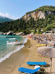 there are many beach chairs and umbrellas on the beach near the water's edge