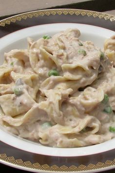 a white plate topped with pasta covered in sauce