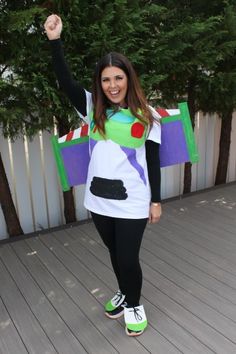 a woman in a costume is standing on a deck with her arms up and smiling